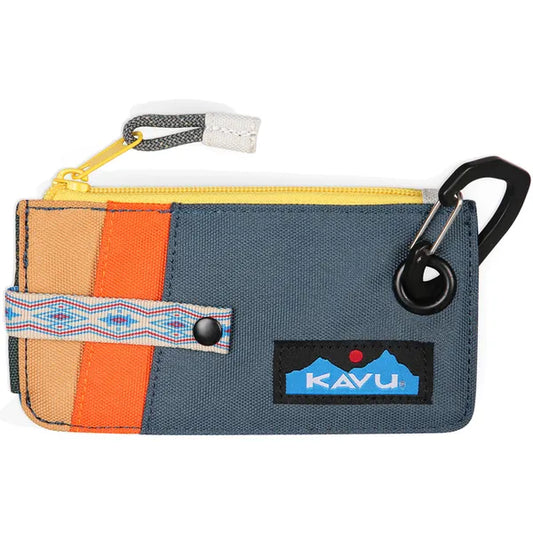 The Kavu Clipper Card Case is a small rectangular wallet with blue, orange, and beige panels, a yellow zipper, patterned strap, metal carabiner clip, and front Kavu logo patch.