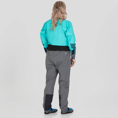 A woman stands facing away in an NRS REV (GORE-TEX Pro) Drytop, teal with gray pants, showcasing its waterproof breathable performance.