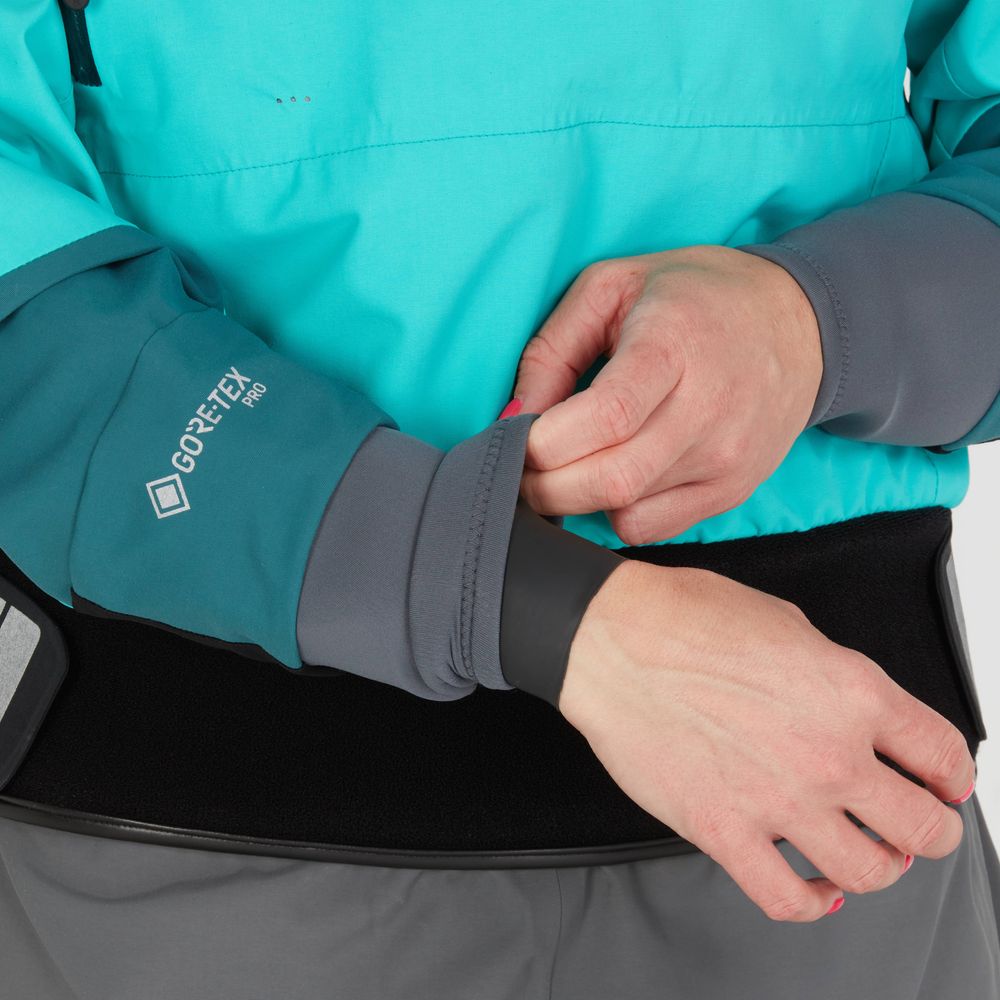 Someone adjusts the sleeve of the NRS REV (GORE-TEX Pro) Drytop for women, with a teal and gray design and a GORE-TEX Pro label on the wrist, highlighting its waterproof breathable performance.