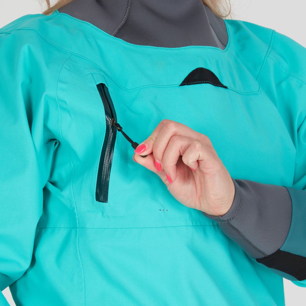 A hand unzips the pocket of a turquoise NRS REV (GORE-TEX Pro) Women's Drytop, its fabric reminiscent of a paddling dry top, showcasing confident movements and hinting at the waterproof breathable performance expected from GORE-TEX Pro technology.