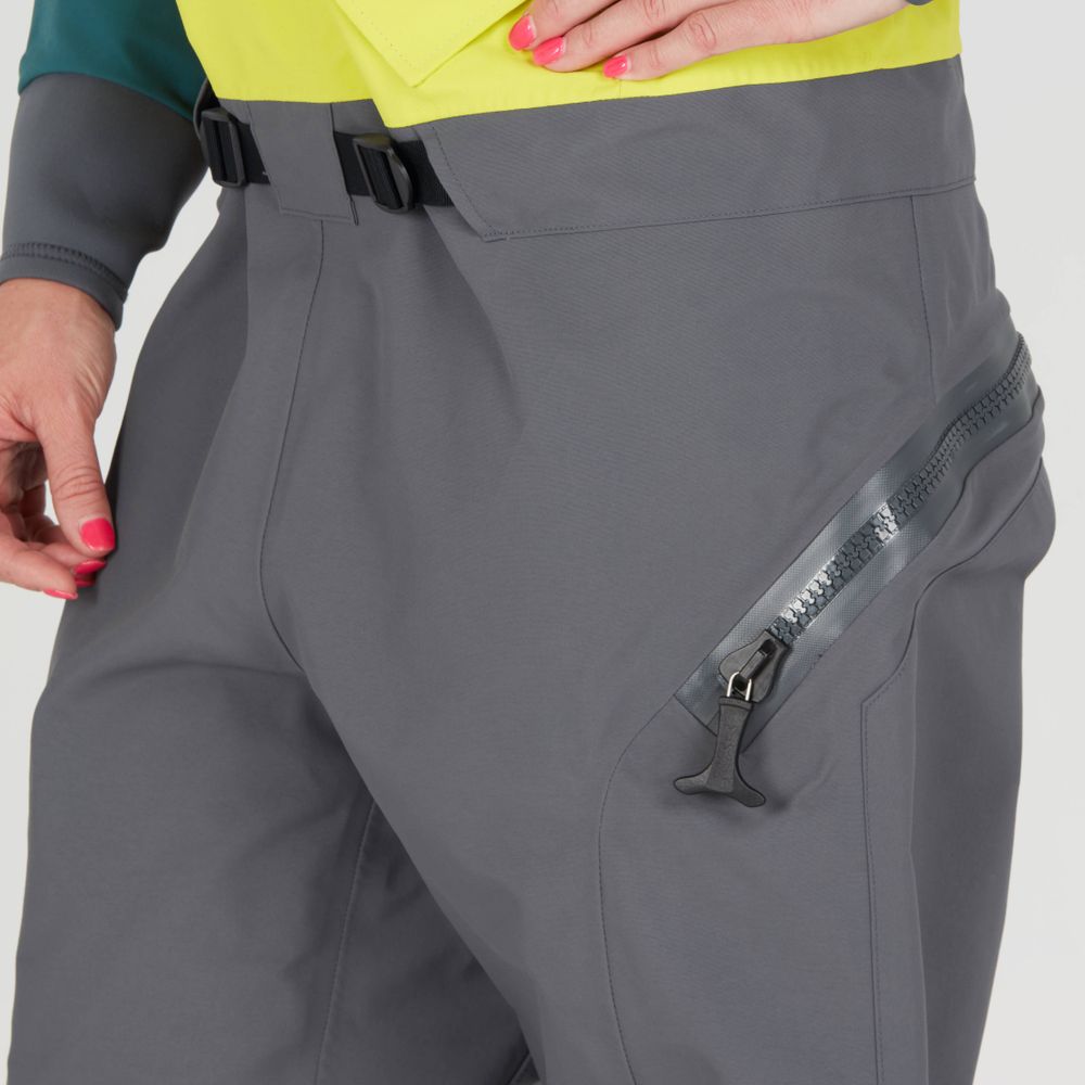 A person is wearing the NRS Nomad GORE-TEX Pro Semi-Dry Suit for women, highlighted by pink-painted nails, showcasing its waterproof performance.