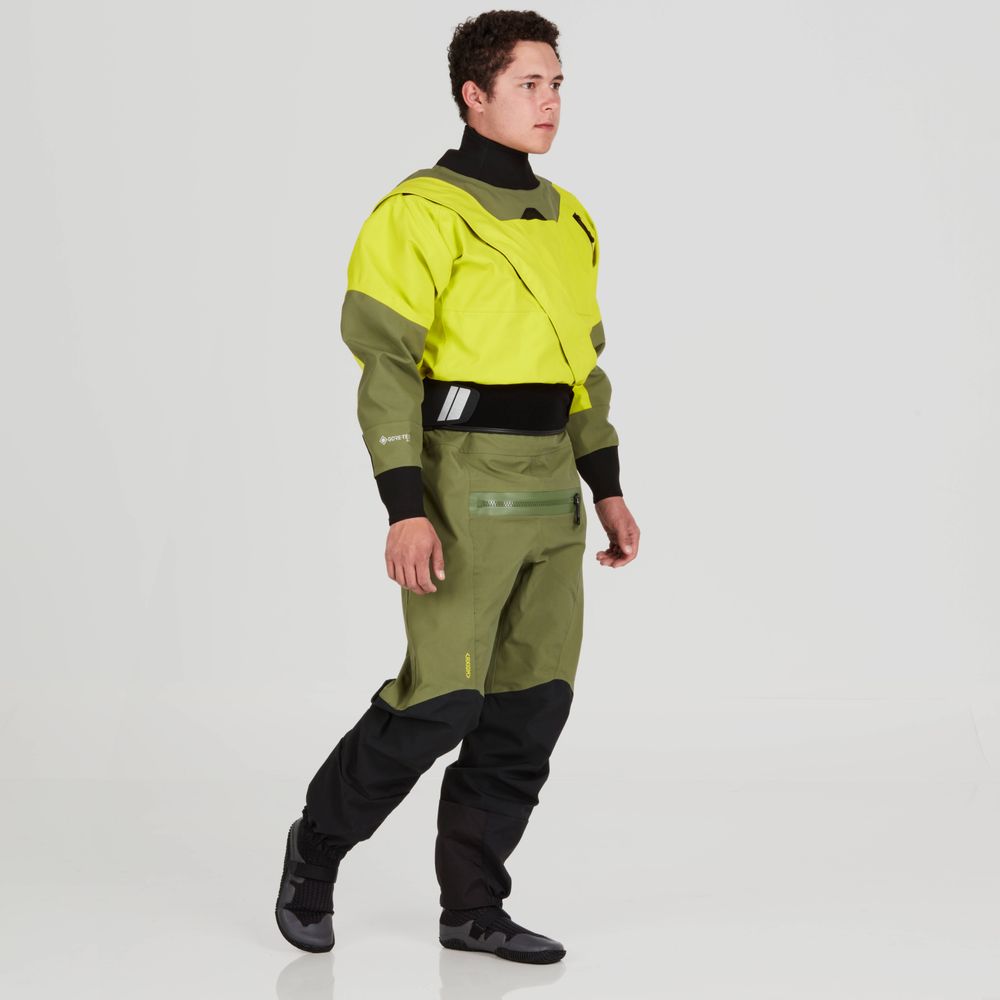 A person is wearing an NRS Axiom (GORE-TEX Pro) Drysuit in yellow and green paired with black boots, standing against a plain white background.