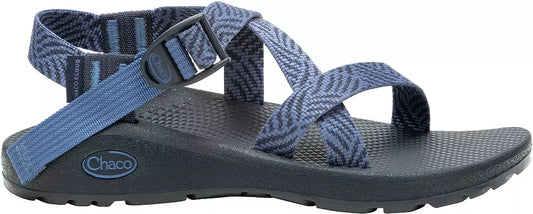 A blue Chaco ZCloud - Women's sandal with adjustable straps, a black textured sole with Cloud Cushioning, a ChacoGrip rubber outsole, and a side buckle is shown against a white background.
