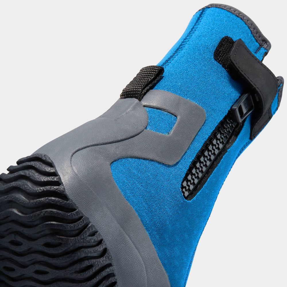Close-up of the NRS Paddle Wetshoe - Women's in blue and gray neoprene with a textured sole, side zipper, and black strap. This footwear is perfect for comfort and durability during aquatic adventures.