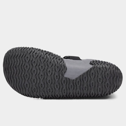 The image shows the NRS Paddle Wetshoe for women, featuring a neoprene design with a textured black sole and wave-pattern tread. The upper part is gray and black.