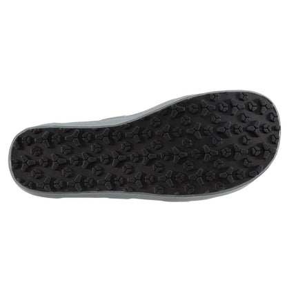 The image displays the sole of the NRS Backwater Wetshoe, featuring hexagonal studs for traction. Ideal for kayakers and anglers, the black sole is shown from a bottom view, emphasizing its grip-enhancing design suitable for wet environments.