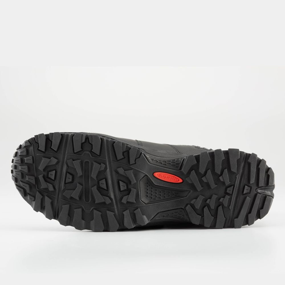 The image showcases the treaded sole of the NRS Storm Boot, a black hiking boot with a HyperGrip sole for improved grip and quick-drying performance.