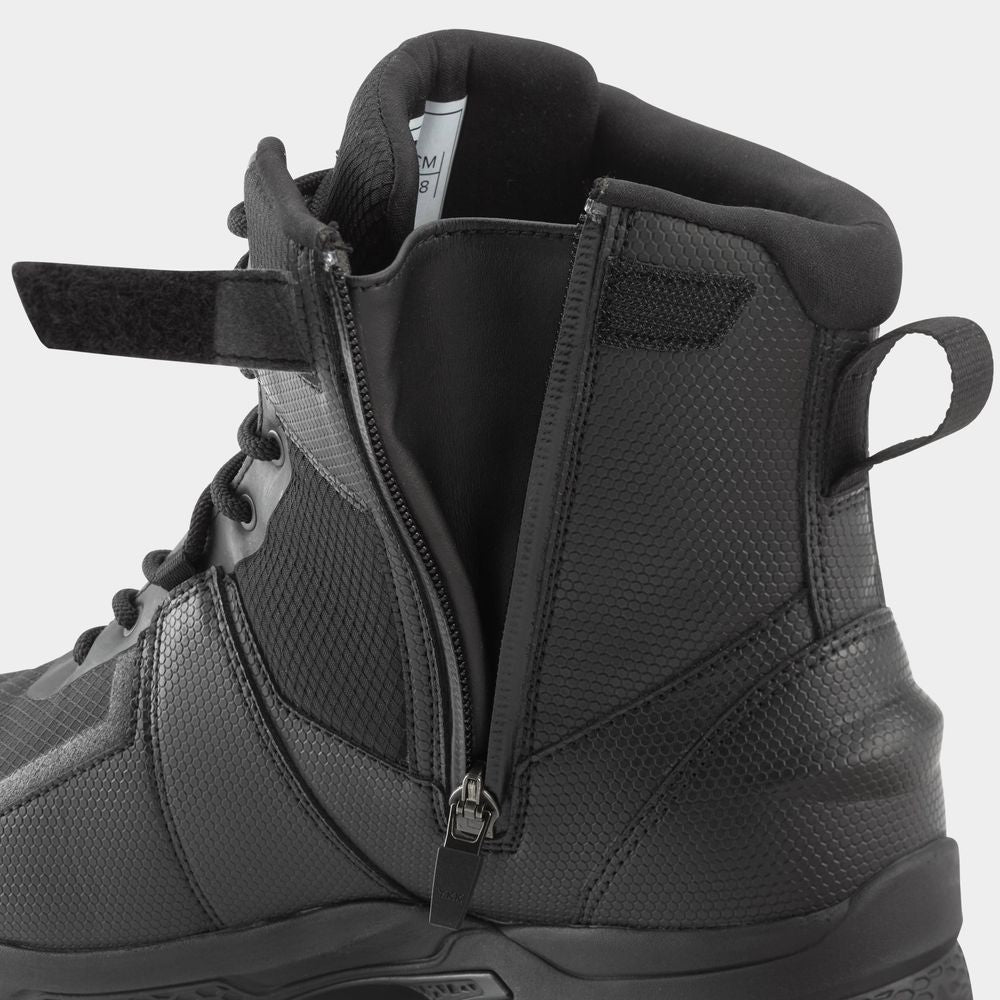 Close-up of the NRS Storm Boot, featuring a black tactical design with a side zipper and hook-and-loop strap. Its HyperGrip sole ensures quick drying, ideal for rugged adventures.