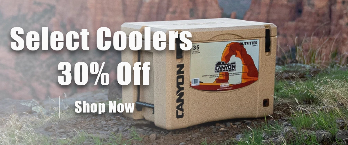 Canyon Outfitter Cooler sitting on the rim of the grand canyon with text overlay saying "select coolers 30% off" and button saying "shop Now"