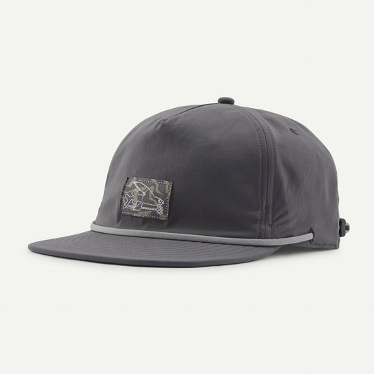 The Patagonia Merganzer Hat is a gray baseball cap featuring a black and white abstract patch on the front, a curved brim, and an adjustable strap at the back.