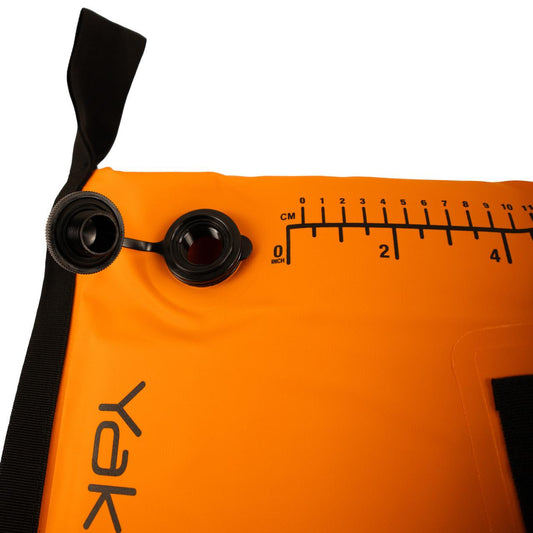 Close-up of an orange inflatable device with a black cap, measurement markings in centimeters and inches, and "Yak" partially visible—ideal for use with your YakAttack Insulated Fish Cooler Bag on fishing trips.