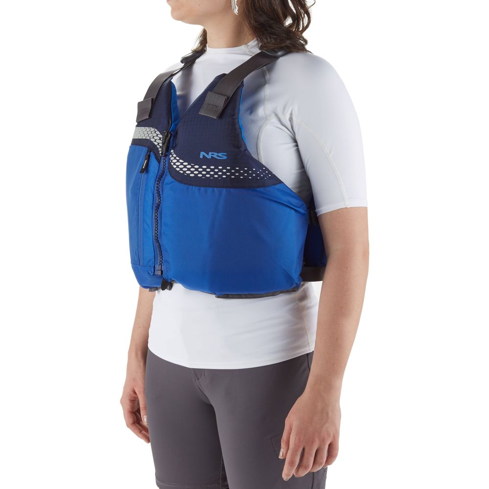 A person stands against a white background wearing an NRS Vista PFD with US Coast Guard Certification over a white shirt and gray shorts.