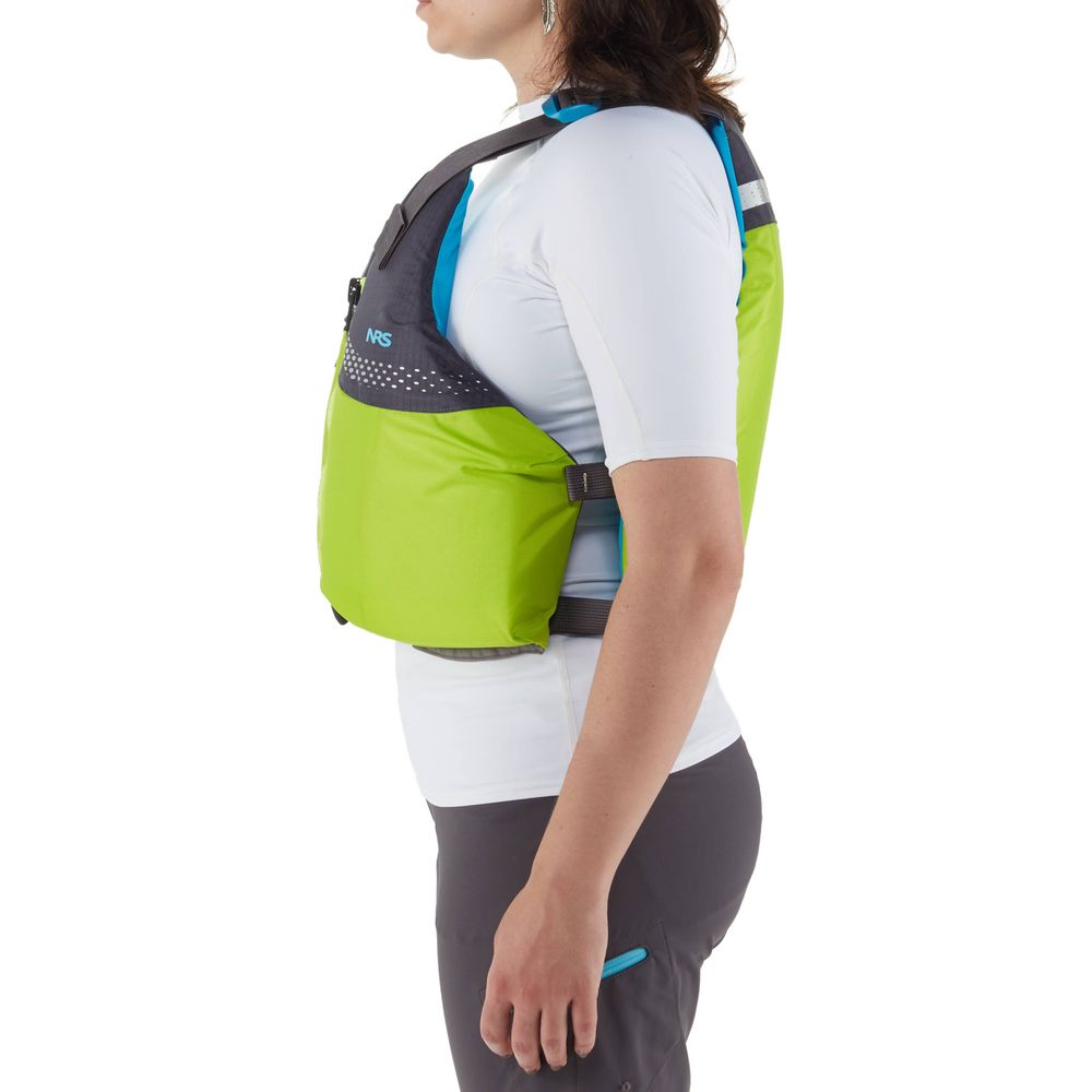 A person stands in profile wearing a lime green NRS Vista PFD, a US Coast Guard Certified life jacket, over a white shirt.