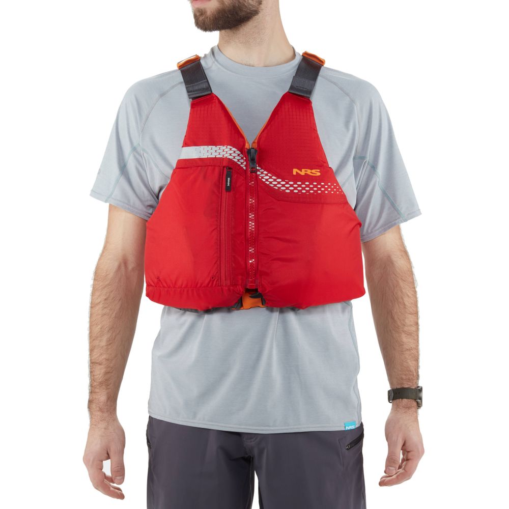 A man in a gray t-shirt stands with arms relaxed, wearing the NRS Vista PFD, a red life jacket with black straps. This beginner's life vest is US Coast Guard certified, ensuring safety and peace of mind on the water.