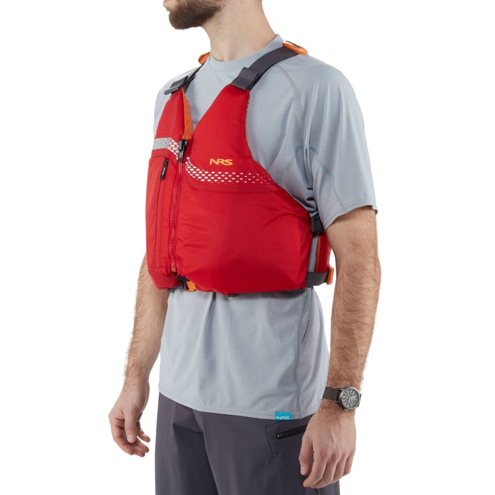 A person wearing a red NRS Vista PFD with US Coast Guard Certification over a gray shirt stands sideways with arms relaxed.