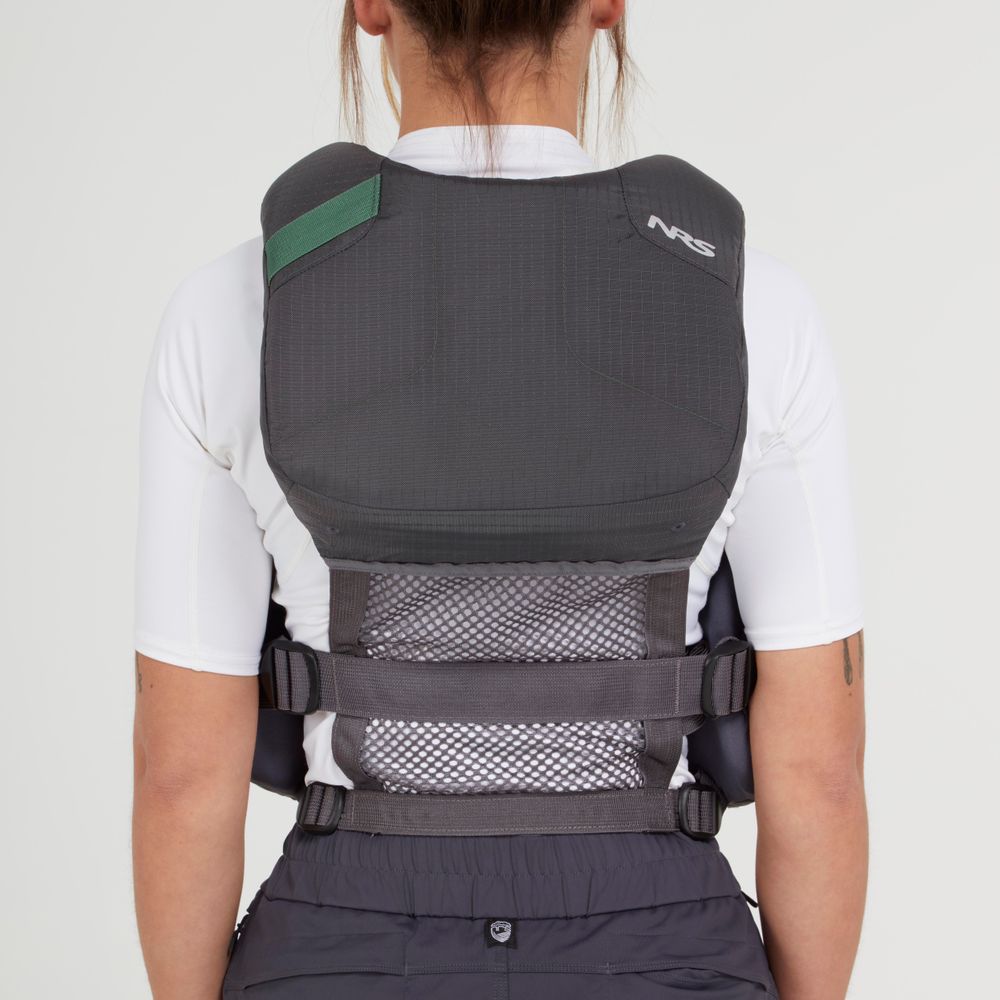 A person faces away, wearing the NRS Chinook Fishing PFD—black and gray with mesh panel and adjustable straps—over a white shirt, against a plain background.