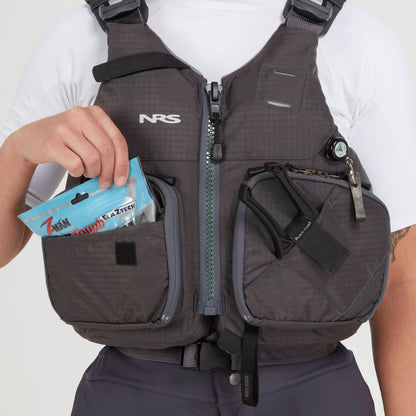 Someone wearing the NRS Chinook Fishing PFD with gear attachment points has a packaged snack in an outer pocket and various accessories clipped on.