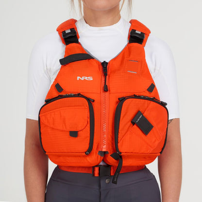 A person is wearing an NRS Chinook Fishing PFD over a white shirt, showcasing an orange design with black straps, pockets, and practical gear attachment points.