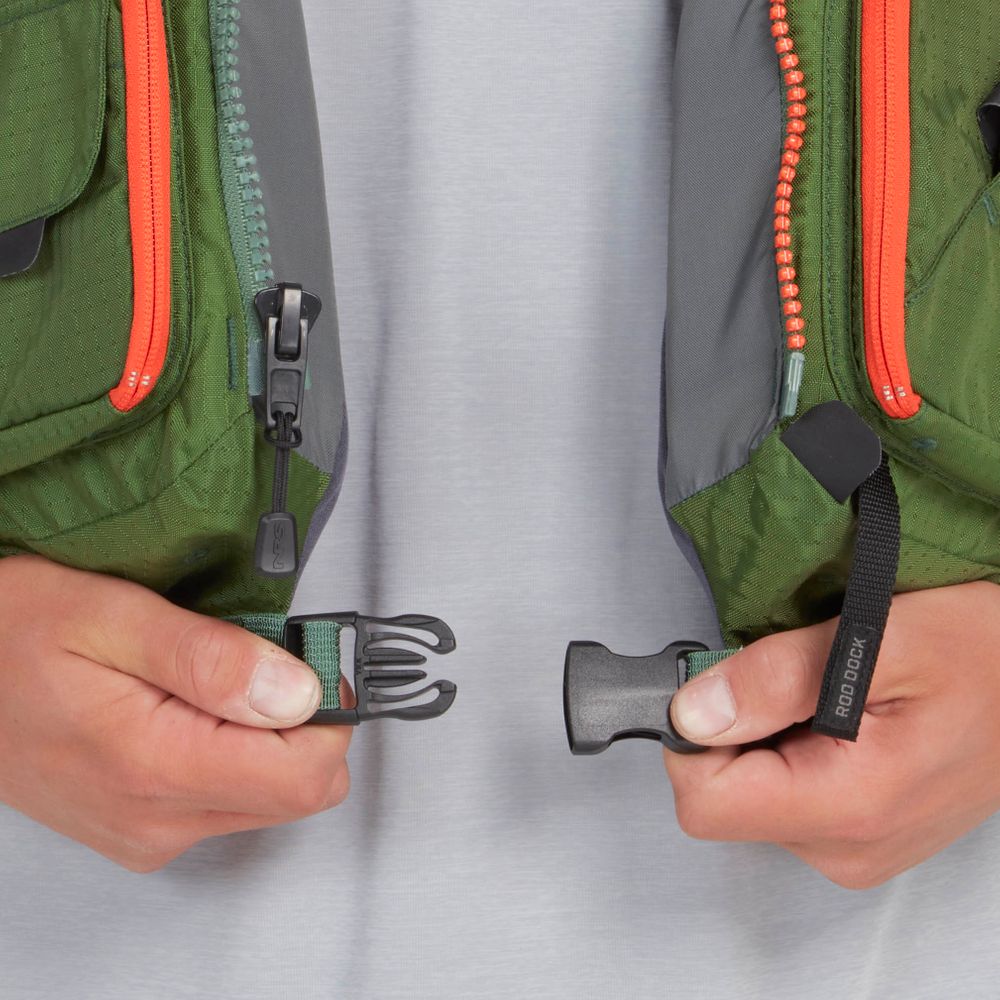 Close-up of hands holding both ends of a black plastic buckle on the NRS Chinook Fishing PFD, which is green and gray with orange zippers.