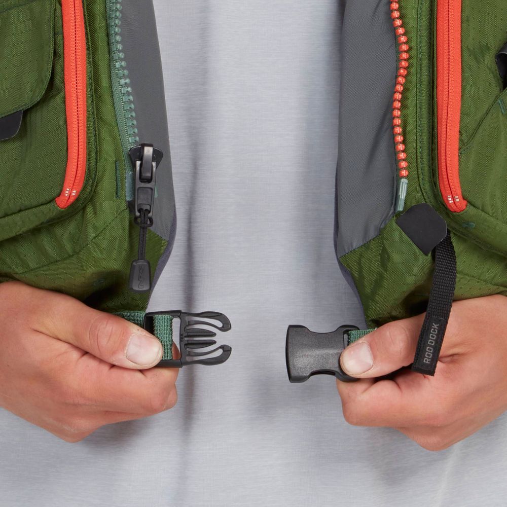 Close-up of hands opening a black plastic buckle on a green and gray NRS Chinook Fishing PFD with red zippers, perfect for fishing adventures.
