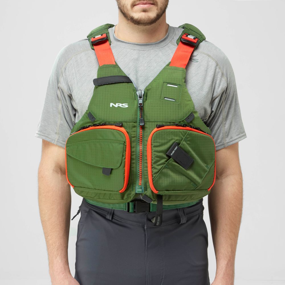 A person wears an NRS Chinook Fishing PFD in green and orange over a gray shirt and dark pants, shown from the front against a plain background.