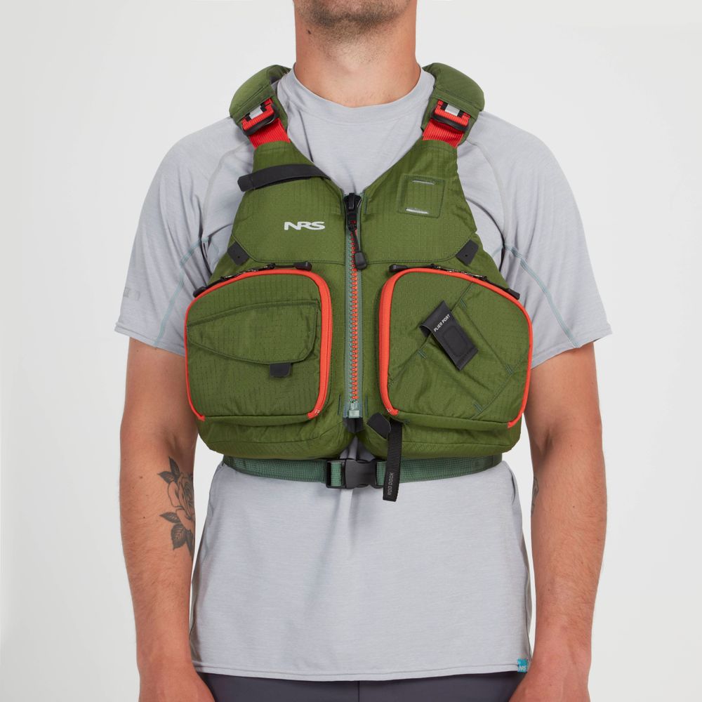 Someone is wearing a green NRS Chinook Fishing PFD over a light gray shirt. The vest includes pockets, a buckle, and various gear attachment points for convenience.