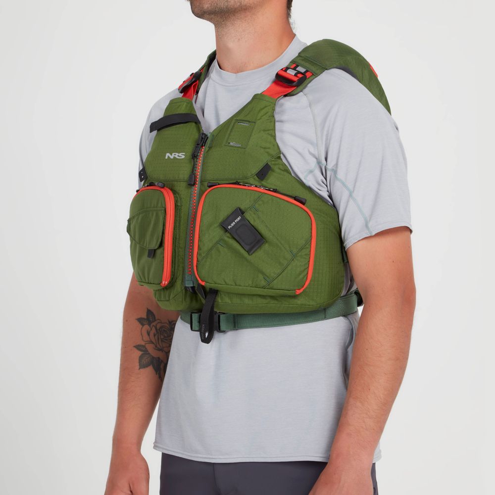A person wearing an NRS Chinook Fishing PFD with multiple pockets and gear attachment points shows off a floral tattoo on their left arm, while donning a gray shirt.