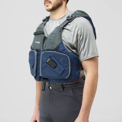 A man in a gray shirt and pants is wearing the NRS Chinook Fishing PFD, a blue and gray life jacket featuring multiple pockets and attachment points.