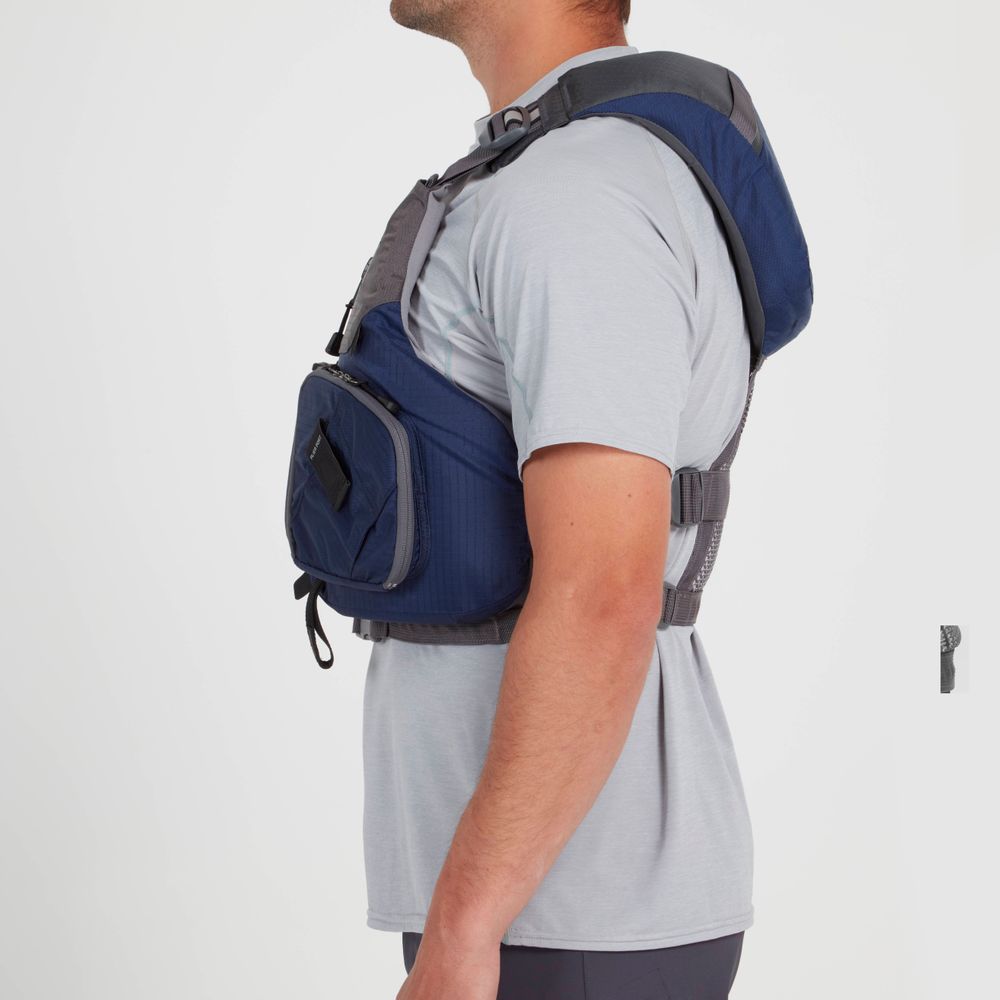 A person is seen from the side wearing an NRS Chinook Fishing PFD, a blue life jacket with gear attachment points, over a gray t-shirt.