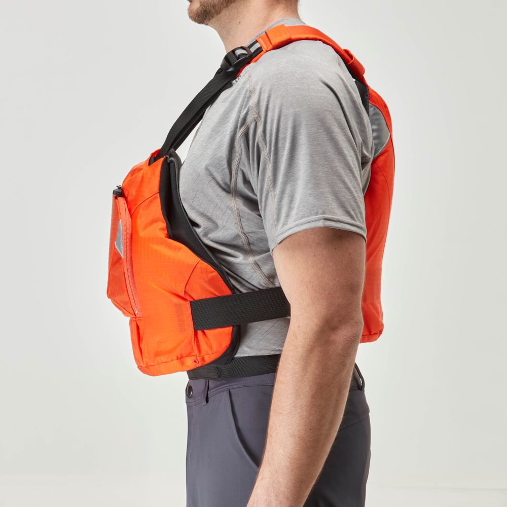 A man, seen from the side, models an orange NRS Ninja PFD while wearing a gray shirt and dark pants. This performance jacket is designed for paddlers, offering flotation in a compact form.