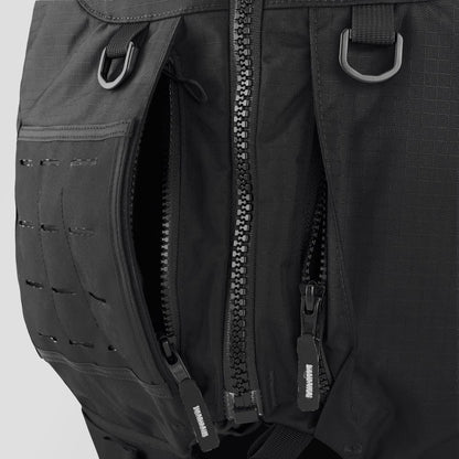 Close-up of a black backpack with heavy-duty zippers, mesh loops, and attachment points—perfect for pairing with the NRS Big Water Guide Hi-Float PFD to boost boating safety with dependable, durable construction.