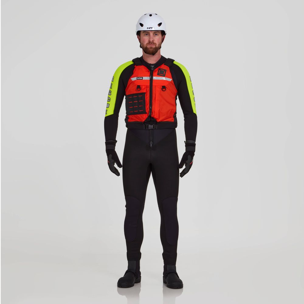 A person stands facing forward wearing an NRS Big Water Guide Hi-Float PFD over an orange and black safety jacket with neon yellow accents, a white helmet, black wetsuit, gloves, and boots against a plain background.