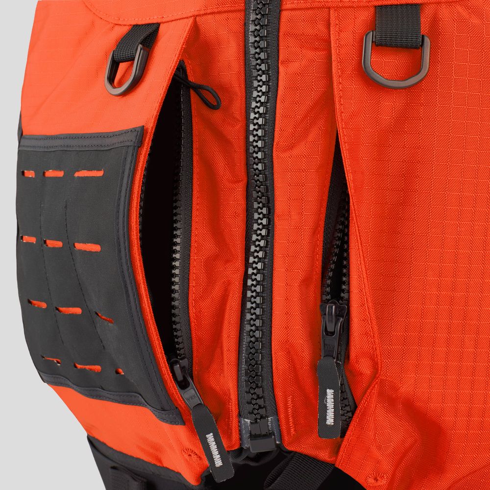 Close-up of an orange backpack with two unzipped compartments, black zipper pulls, and attachment loops—perfect for storing boating safety essentials like the NRS Big Water Guide Hi-Float PFD.