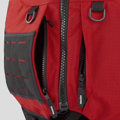 Close-up of a red backpack with multiple zippers, black buckles, and a gray pocket—mirroring the rugged durability of the NRS Big Water Guide Hi-Float PFD.