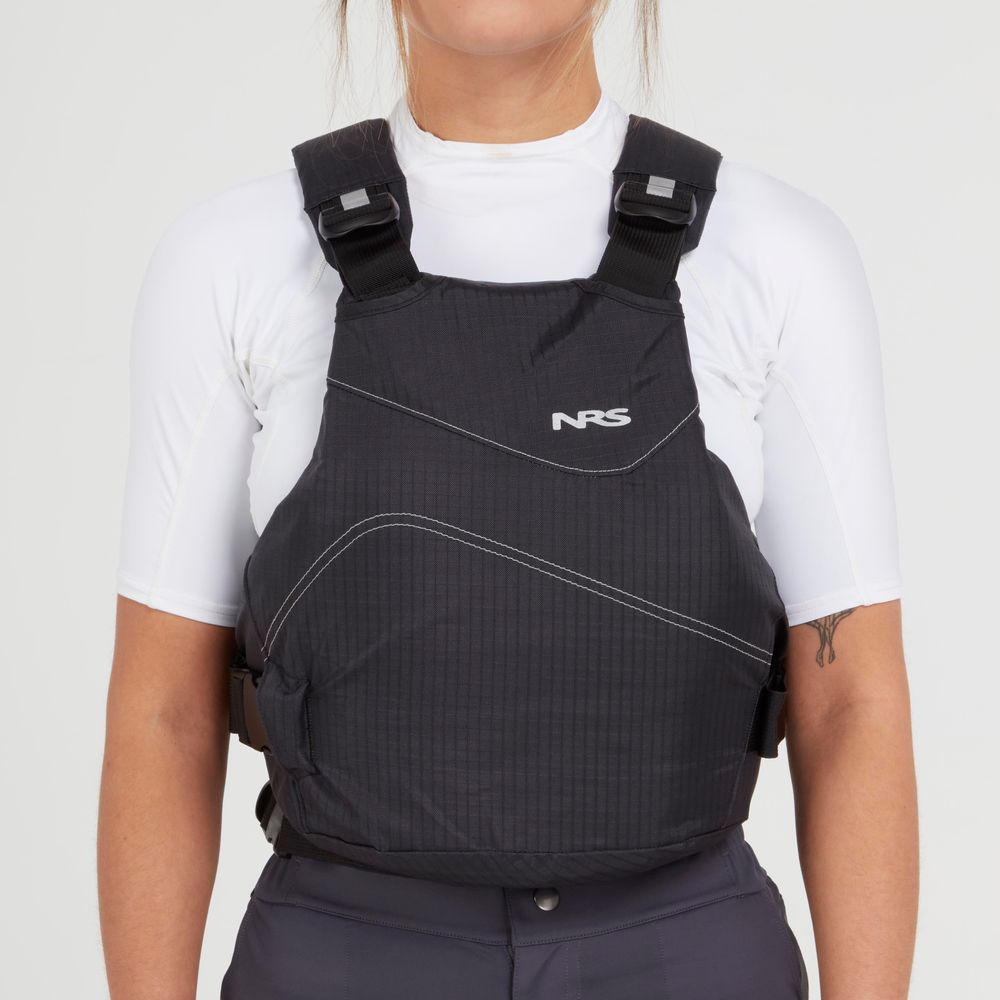 A person wearing the NRS Vapor PFD paddling life jacket over a white short-sleeve shirt, shown from the front against a plain background.