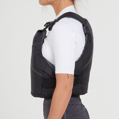 A person is shown from the side against a plain background, wearing an NRS Vapor PFD in black over a white shirt.
