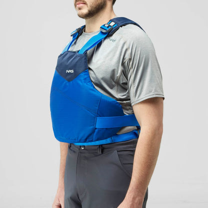 A man wears the NRS Vapor PFD life jacket over a grey short-sleeve shirt and dark pants, standing against a plain light background—ready for paddling adventures.