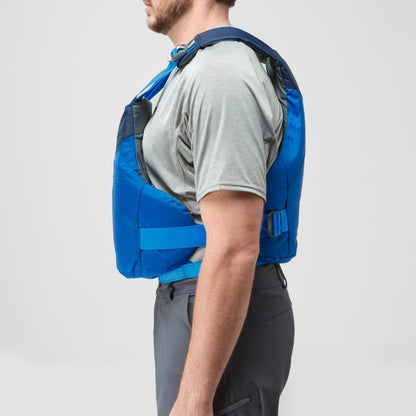 A man in a grey shirt and dark pants stands in profile against a plain background, wearing the blue NRS Vapor PFD life jacket.