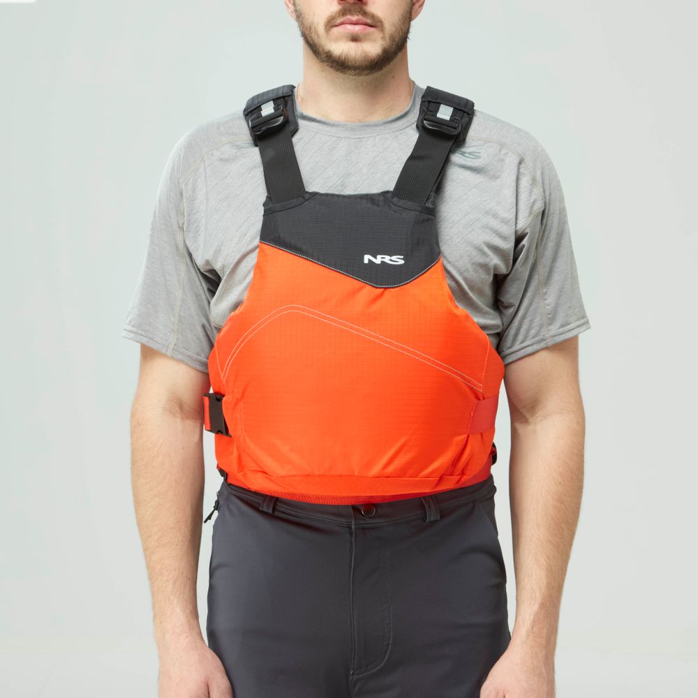 Someone in a grey t-shirt and black pants wears the NRS Vapor PFD, an orange life jacket, securely fastened for paddling adventures.