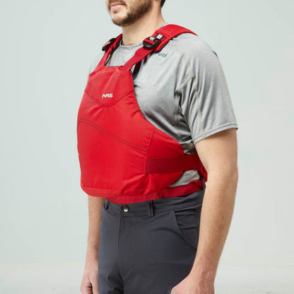 A person wearing an NRS Vapor PFD life jacket over a gray short-sleeve shirt and dark pants stands against a plain light background.