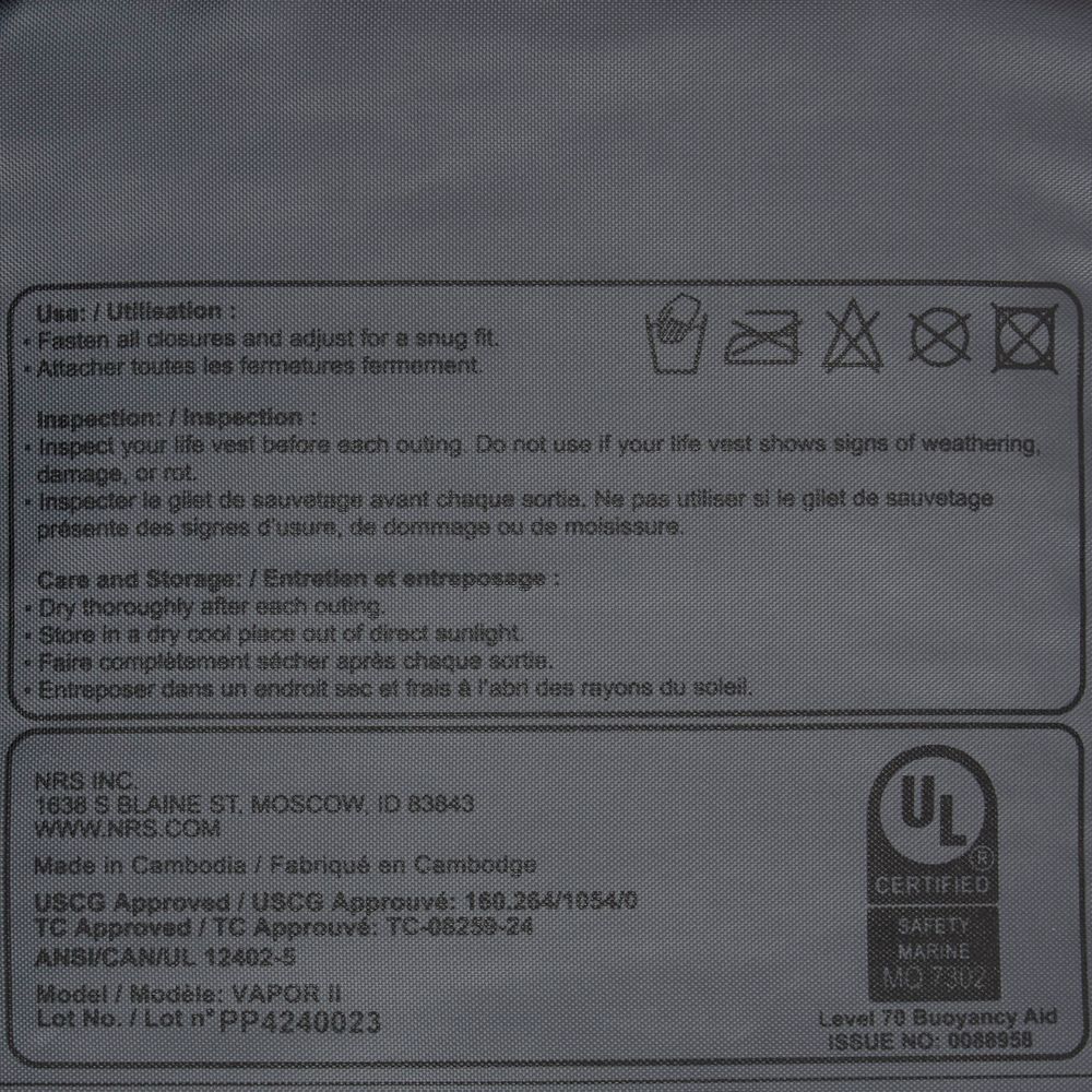 Close-up of the NRS Vapor PFD label showing safety instructions, certifications, usage and inspection details, paddling guidelines, storage info, and manufacturer data.
