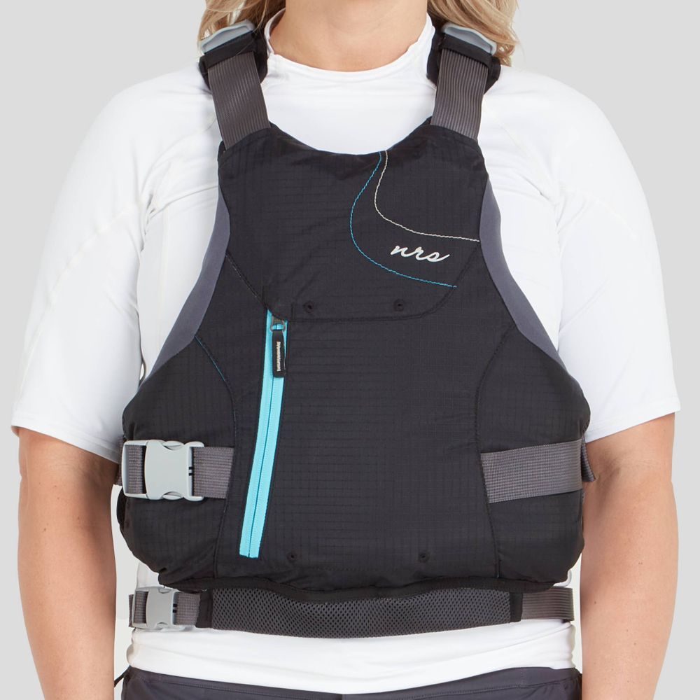 A person is wearing the NRS Siren PFD - Women's, featuring a black design with a blue zipper and gray straps over a white shirt, ensuring an adjustable fit for comfort.