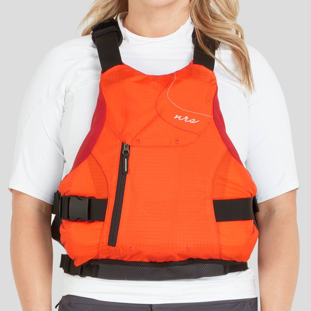 Wearing the NRS Siren PFD - Women's over a white shirt, one enjoys the comfort and adjustable fit of its orange design with black straps, providing safety without sacrificing style.