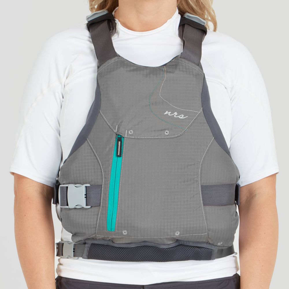 The person is wearing the NRS Siren PFD - Women's, featuring a gray life jacket with a teal zipper over a white short-sleeve shirt, offering comfort and an adjustable fit.