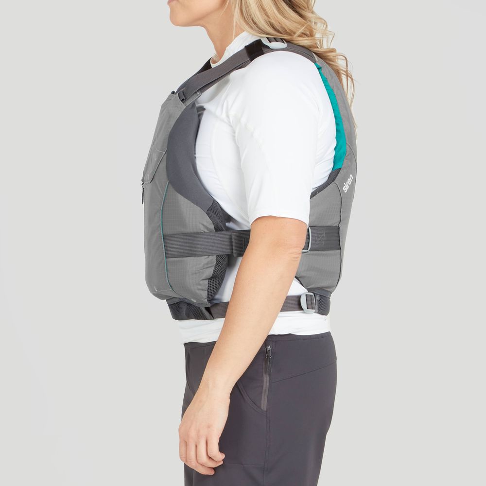 A woman in a profile view wears an NRS Siren PFD in grey over a white shirt and dark pants. The adjustable fit offers comfort and safety against a plain background.