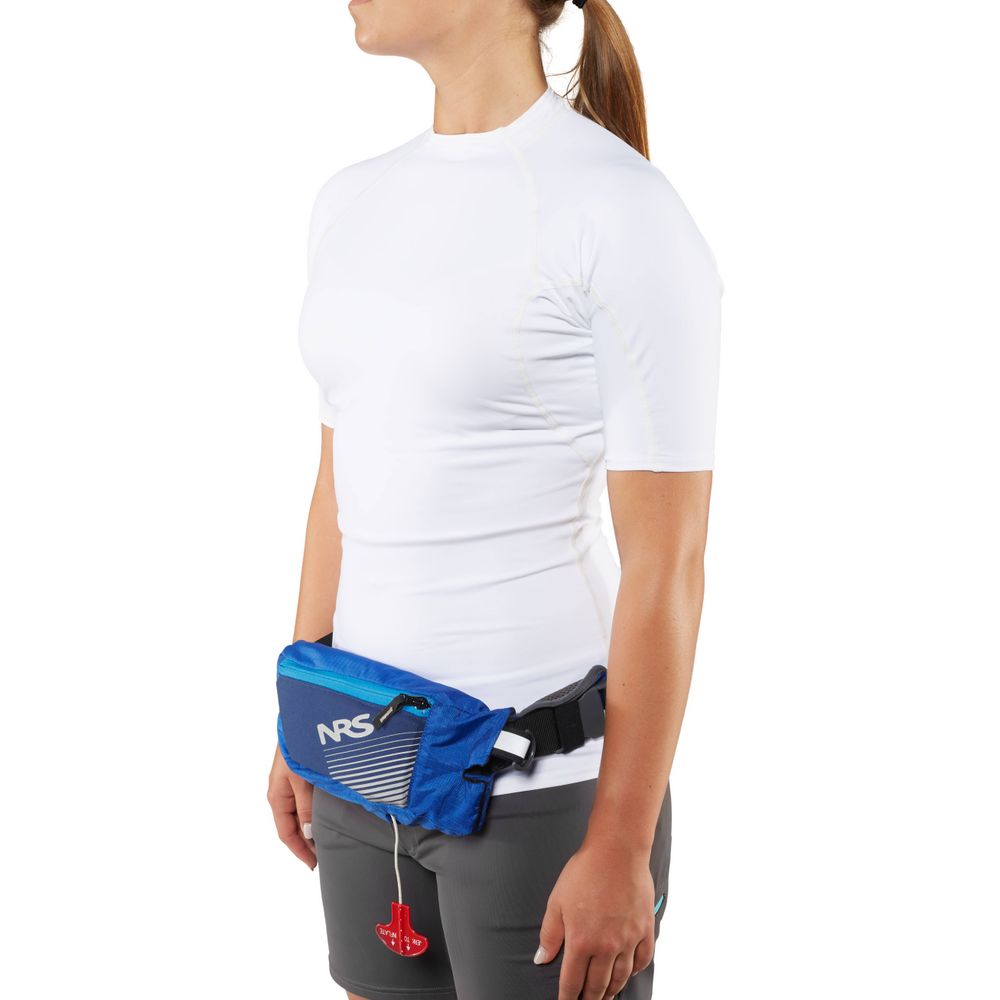 Someone in a white shirt and gray shorts with a blue waist pack featuring a red pull tab, ideal for carrying the sleek NRS Zephyr Inflatable PFD, perfectly complements any standup paddleboard accessory collection.