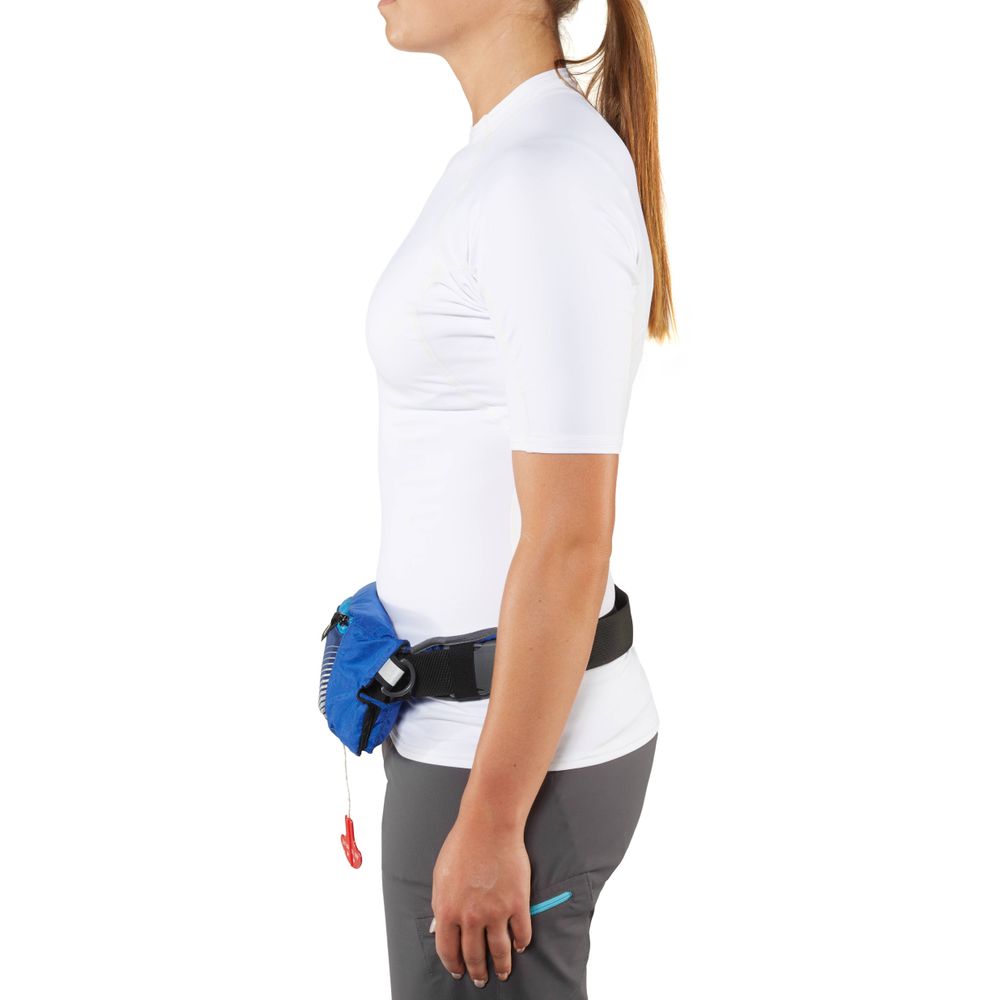 Side view of a person wearing a white shirt and gray pants, with the NRS Zephyr Inflatable PFD stylishly clipped around their waist as they prepare for an adventure.