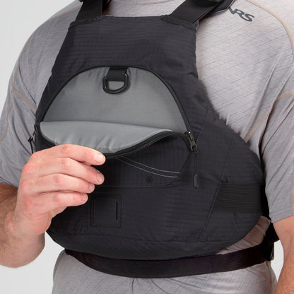 A person in a grey shirt adjusts the NRS Ion PFD, a black chest harness with a zippered pocket and ultra-soft foam for added comfort.