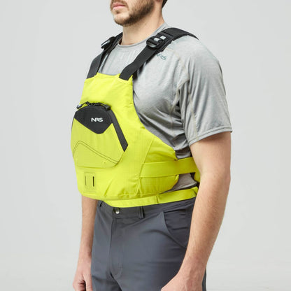A person in a gray shirt and dark pants models the NRS Ion PFD, a US Coast Guard-approved, bright yellow life jacket with black accents, shown from the side.