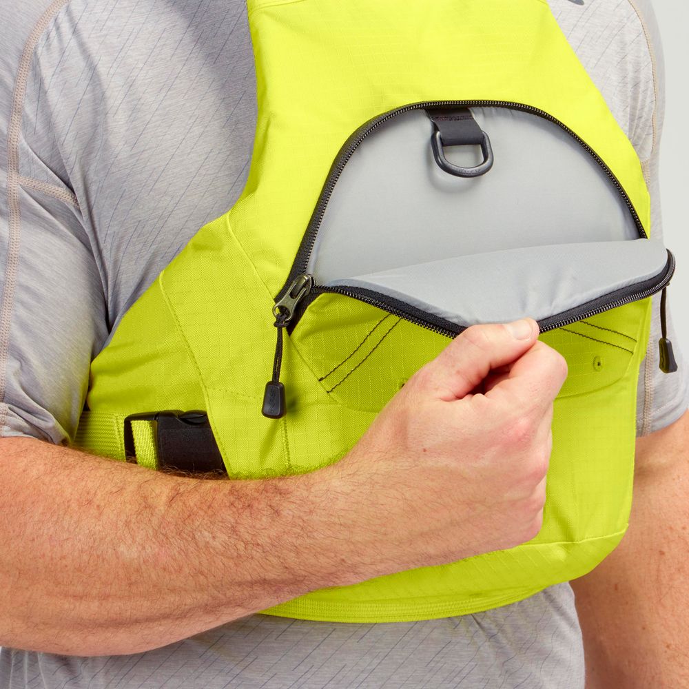 A person opens the front zippered pocket of the bright yellow NRS Ion PFD life jacket, revealing its gray interior lining.
